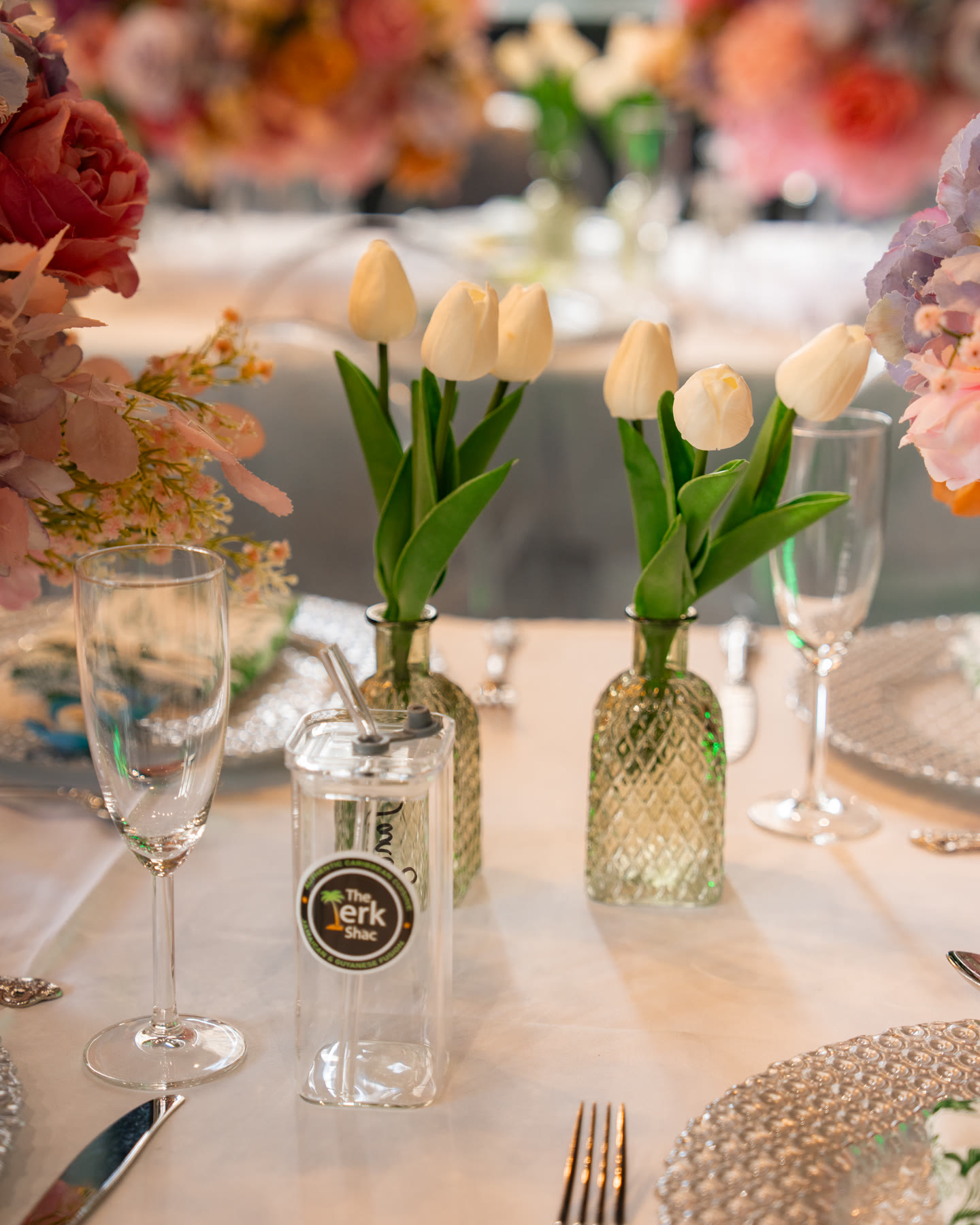 White tulips, glassware and branded table details